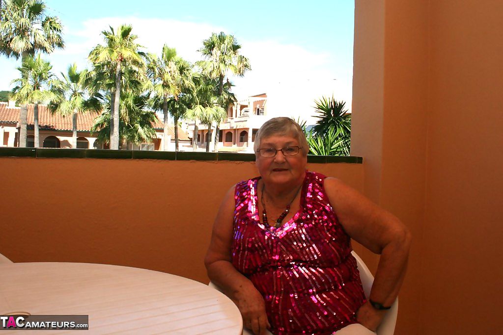 Obese grandmother GrandmaLibby parts her labia lips after disrobing on balcony
