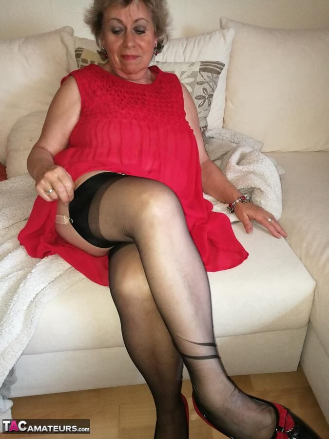 Naughty granny exposes her boobs while changing attire in nylons and heels