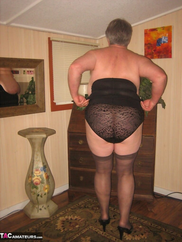 Fat old woman Girdle Goddess doffs black lingerie to pose nude in stockings