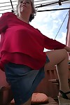 Horny oma spreads her upskirt pussy after pulling down her hose on patio