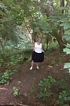 Mature amateur whore Caro masturbating on the bench in the woods