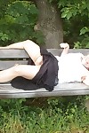 Mature amateur whore Caro masturbating on the bench in the woods