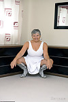 Fun loving hot granny Savana squats to flash naked upskirt in high heel boots