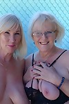 Mature ladies go topless while while humping each other on bar stools