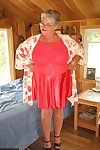 Short haired granny Girdle Goddess stripping to her stockings and high heels