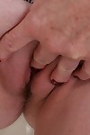 Chunky granny Judy Belkins revealing shaved pussy and large boobs
