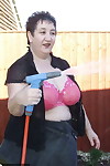 Fat old lady Kinky Carol bares her big tits while soaping up during a car wash