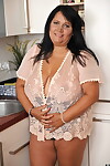BBW brunette Bubi poses and displays her big natural tits in a kitchen
