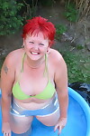 Older redheaded BBW Valgasmic Exposed plays with a dildo in a wading pool