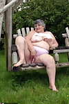 Old British woman Grandma Libby exposes her boobs on a backyard bench swing