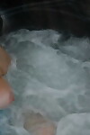 Old woman Valgasmic Exposed plays with her breasts while hot tubbing