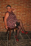 Fat old woman strips to black stockings and heels with her glasses on