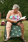 Naughty amateur granny Libby inserting a bottle in her fat pussy in the garden