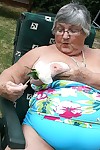 Naughty amateur granny Libby inserting a bottle in her fat pussy in the garden
