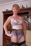 Horny granny laughingly displays the wet cameltoe under her sheer undies